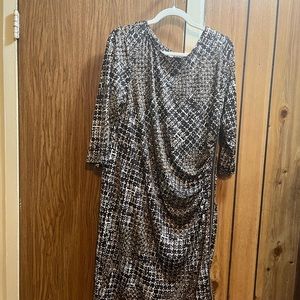 Plus size dress with side draping and zipper.